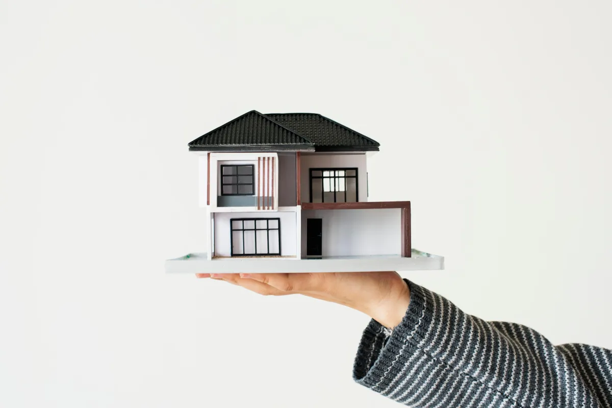 flat hand holding a house