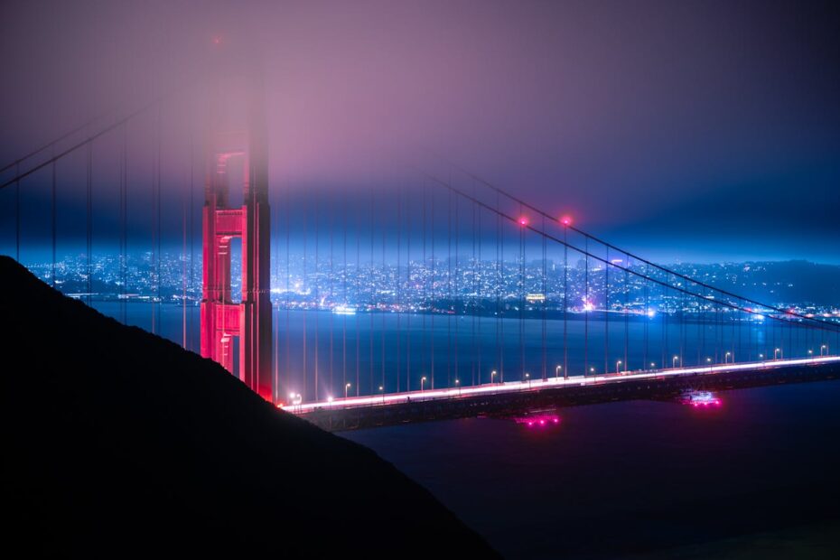 evening fog over lighted Golden Gate Bridge